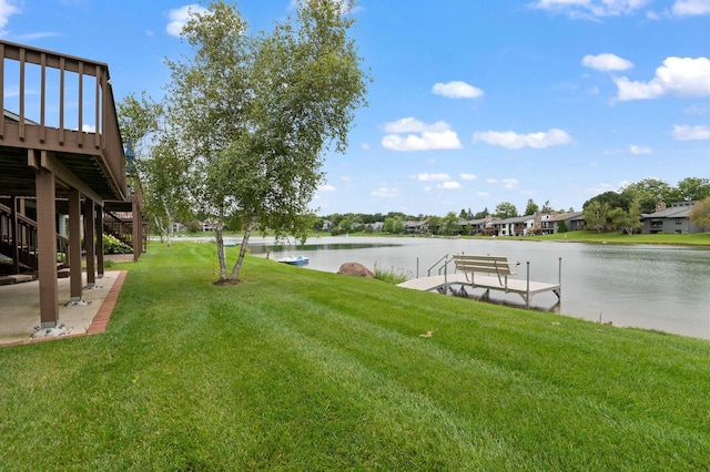 view of yard with a dock and a deck with water view