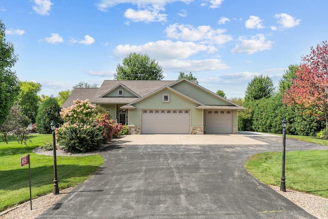 craftsman house with a front lawn and a garage