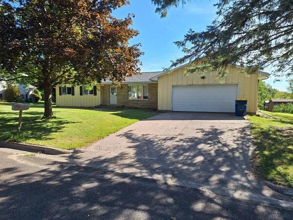 view of front of house with a front lawn and a garage