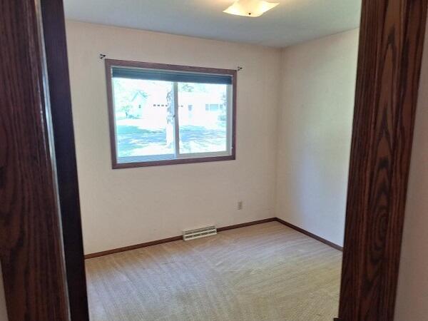 unfurnished room featuring light colored carpet