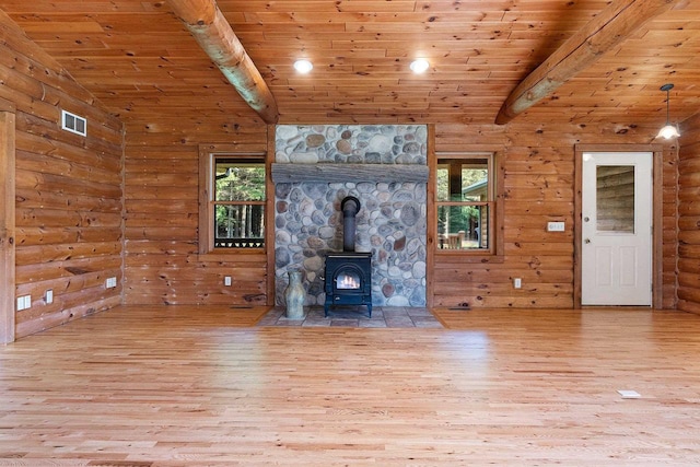 unfurnished living room featuring a wood stove, wood ceiling, lofted ceiling with beams, and wood finished floors