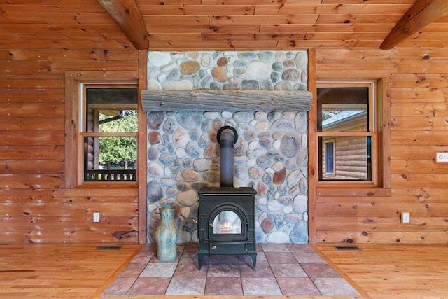 details with a wood stove, hardwood / wood-style flooring, beamed ceiling, and wooden ceiling