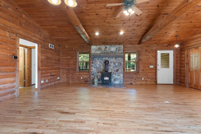 unfurnished living room featuring wooden ceiling, lofted ceiling with beams, a wood stove, and wood finished floors