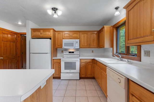 kitchen with light tile patterned flooring, white appliances, a sink, light countertops, and brown cabinets