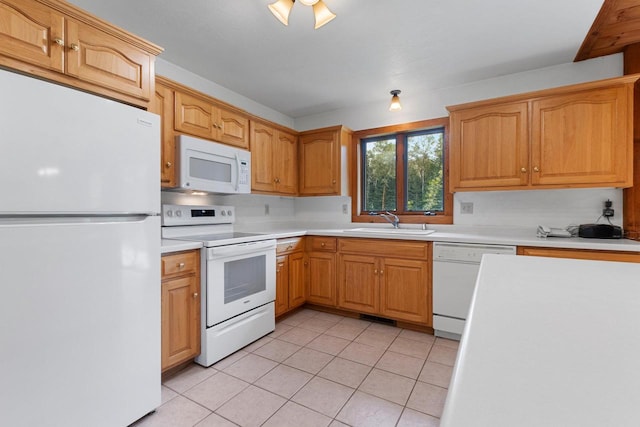 kitchen featuring white appliances, light countertops, a sink, and light tile patterned flooring