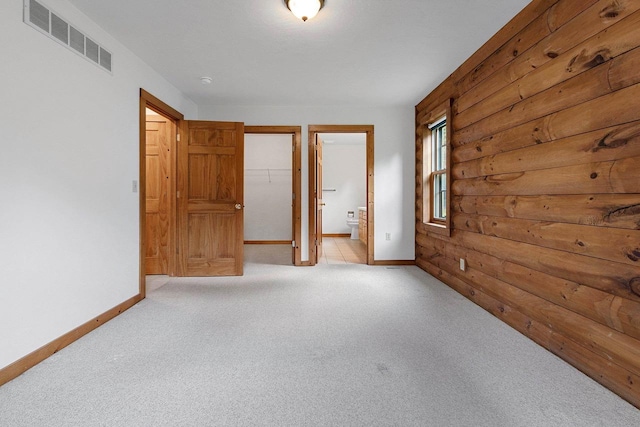 empty room with light carpet, baseboards, and visible vents