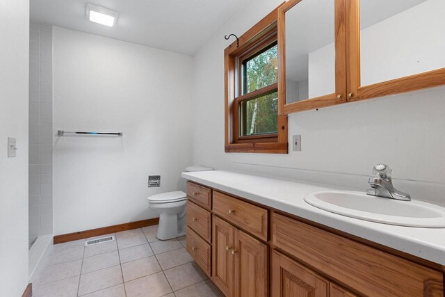 bathroom with vanity, toilet, and tile patterned flooring