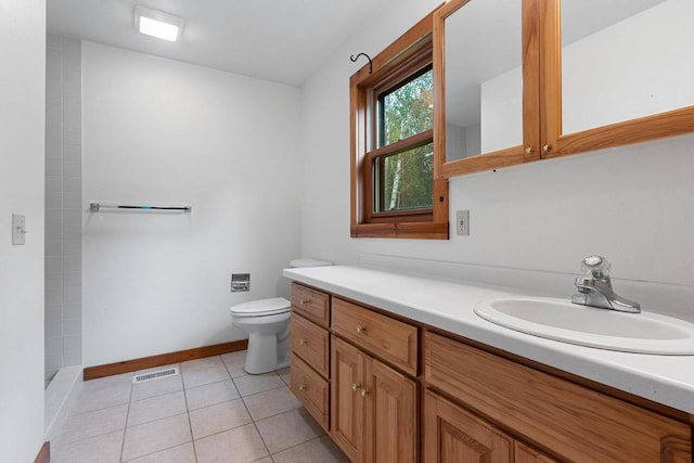 full bath with toilet, vanity, visible vents, a tile shower, and tile patterned floors