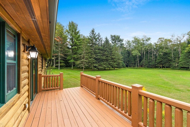 wooden terrace featuring a lawn