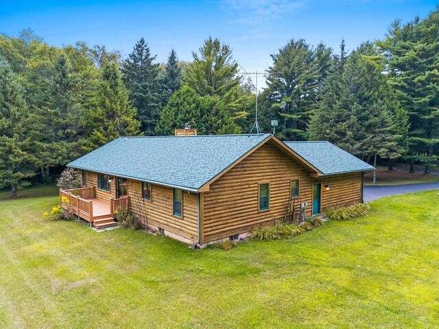 view of front of home featuring a deck and a front lawn