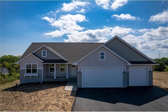 view of front of house with covered porch and a garage