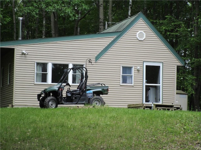 rear view of house featuring a yard