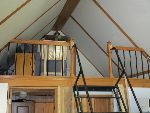 stairway with vaulted ceiling with beams