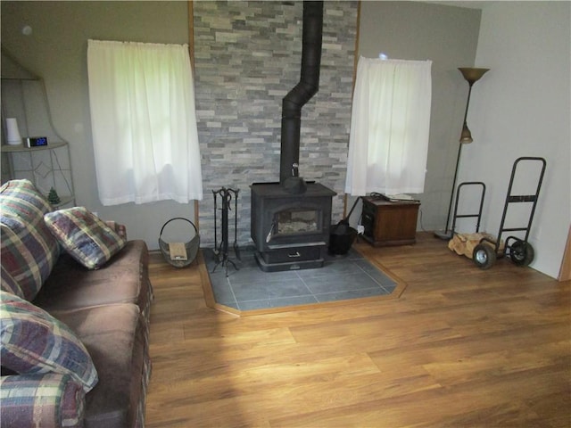 living room featuring a wood stove and hardwood / wood-style flooring