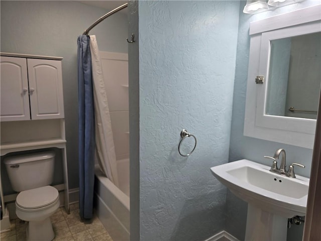 full bathroom featuring toilet, shower / tub combo with curtain, sink, and tile patterned floors