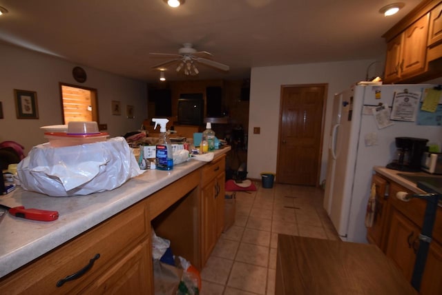 kitchen with ceiling fan, white fridge, and light tile patterned floors