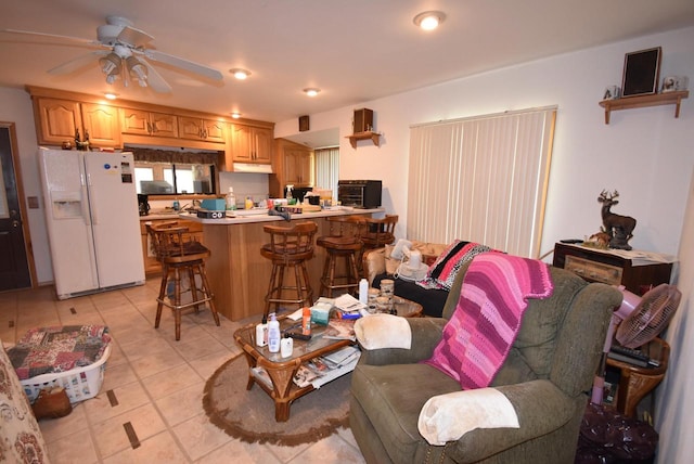 tiled living room with ceiling fan