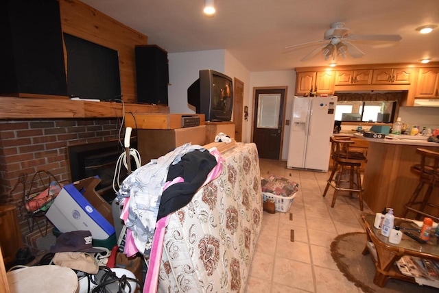 kitchen with ceiling fan, range hood, light tile patterned floors, and white refrigerator with ice dispenser