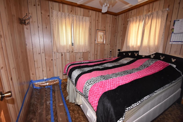 bedroom featuring ceiling fan and wood walls