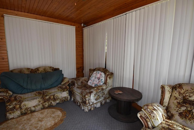 living area with wooden walls and wooden ceiling