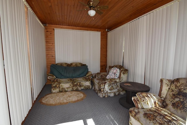 sitting room featuring carpet flooring, ceiling fan, and wood ceiling