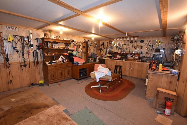 interior space featuring a workshop area and wooden walls