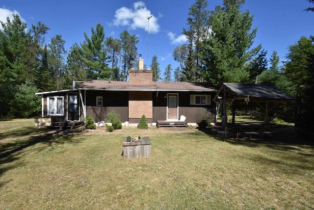 rear view of house with a yard