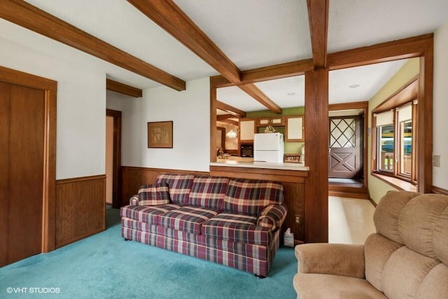 living area with beamed ceiling, wainscoting, carpet flooring, and wooden walls