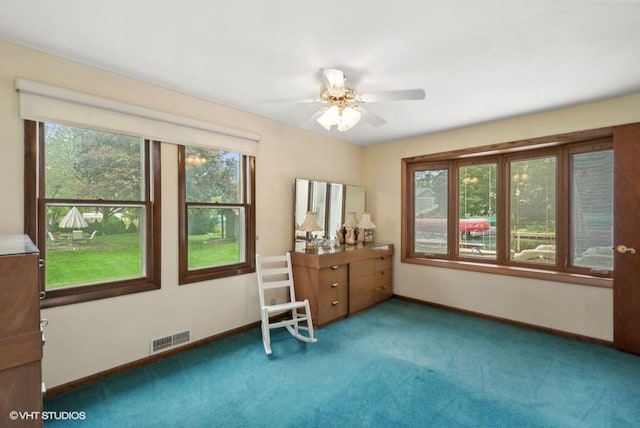 interior space with visible vents, ceiling fan, and baseboards