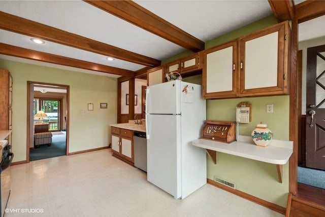 kitchen featuring visible vents, beam ceiling, freestanding refrigerator, dishwasher, and light floors