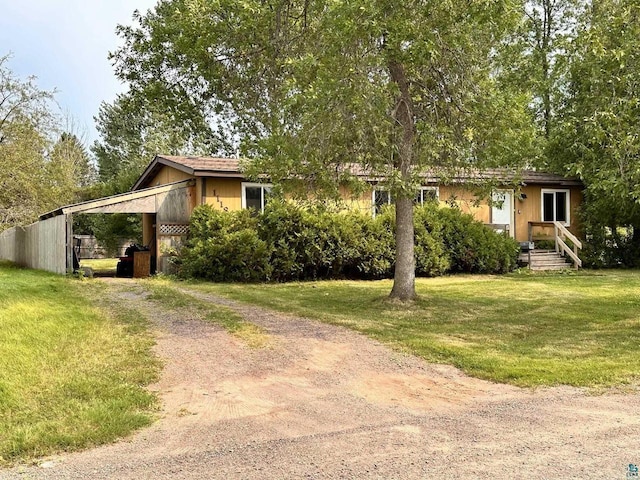 1118 Prentice Ave, Ashland, WI 54806 - view of front of house featuring dirt driveway, a front yard, and a carport