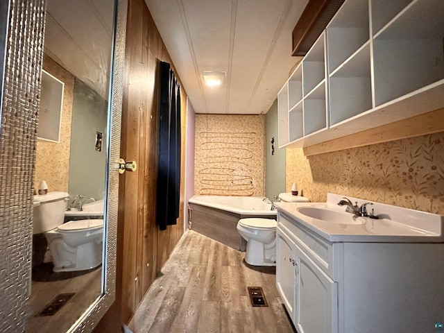 1118 Prentice Ave, Ashland, WI 54806 - bathroom with toilet, wood finished floors, a tub to relax in, and vanity