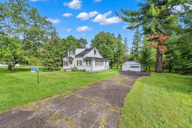 151972 Wren St, Wausau, WI 54401 - view of front of property featuring a garage, a chimney, an outdoor structure, a front lawn, and view of wooded area
