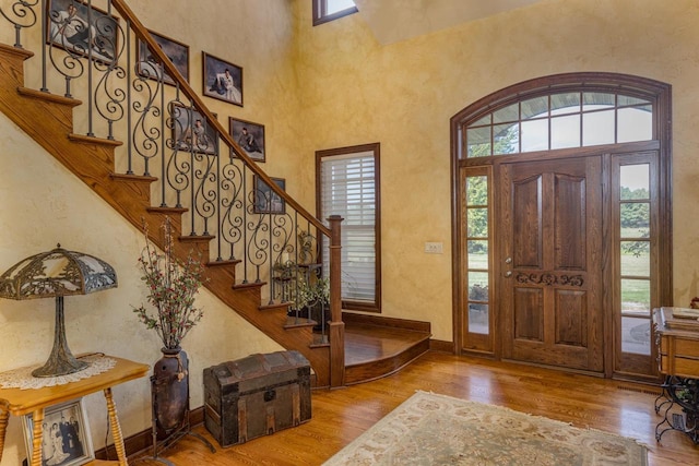 entryway with a high ceiling and hardwood / wood-style floors