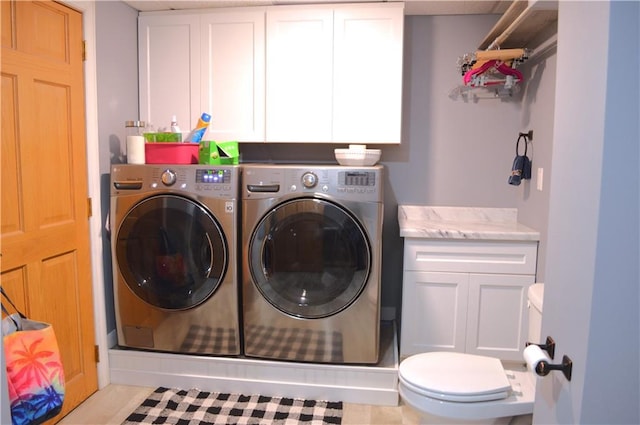 laundry room with light tile patterned floors and washer and dryer