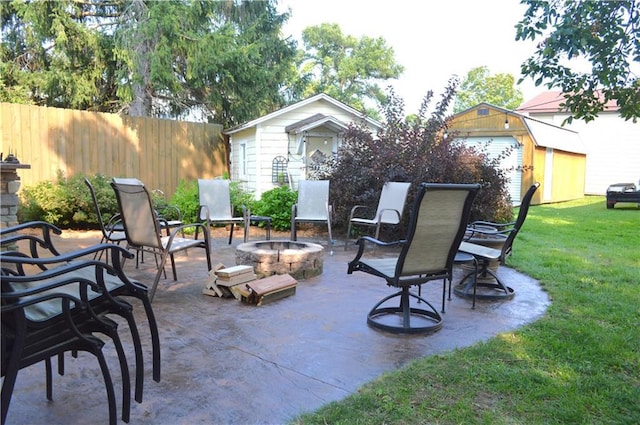 view of patio with a storage unit and a fire pit