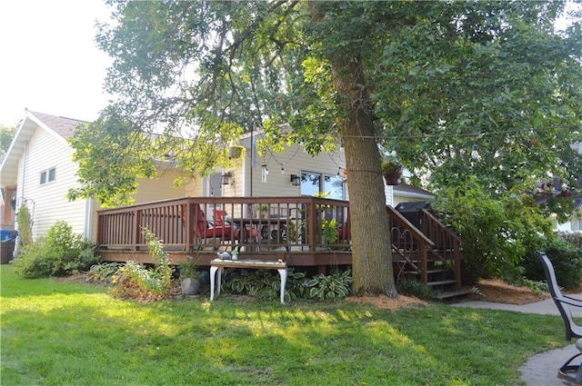 back of property featuring a lawn and a deck