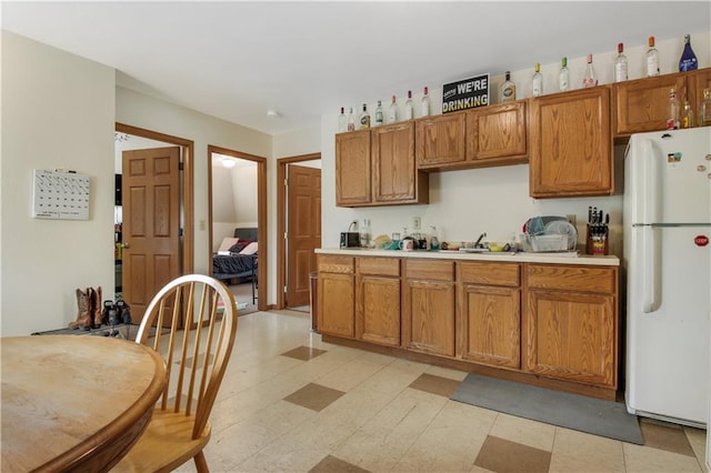 kitchen with sink and white refrigerator