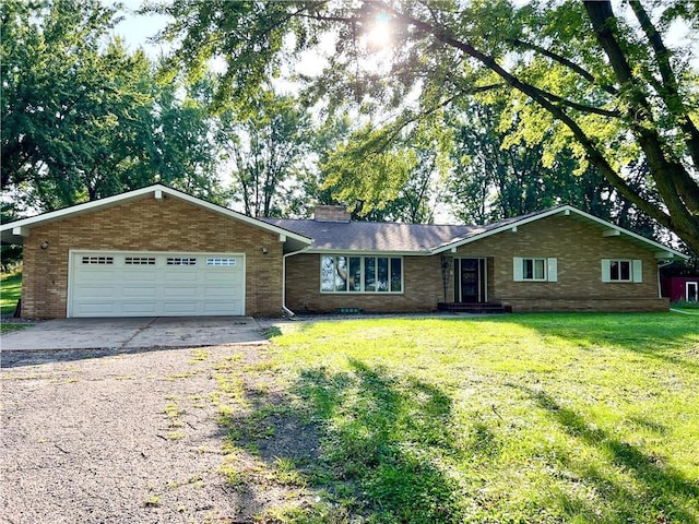 ranch-style house featuring a garage and a front yard