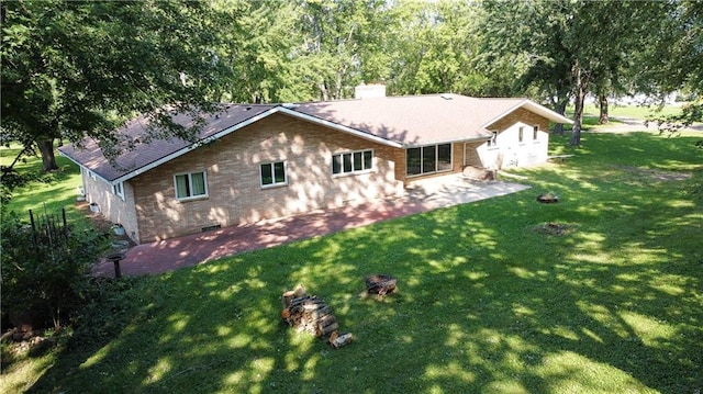 rear view of house featuring a yard and a patio area