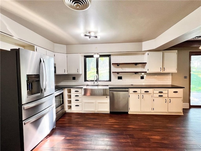 kitchen featuring white cabinetry, tasteful backsplash, stainless steel appliances, sink, and dark wood-type flooring