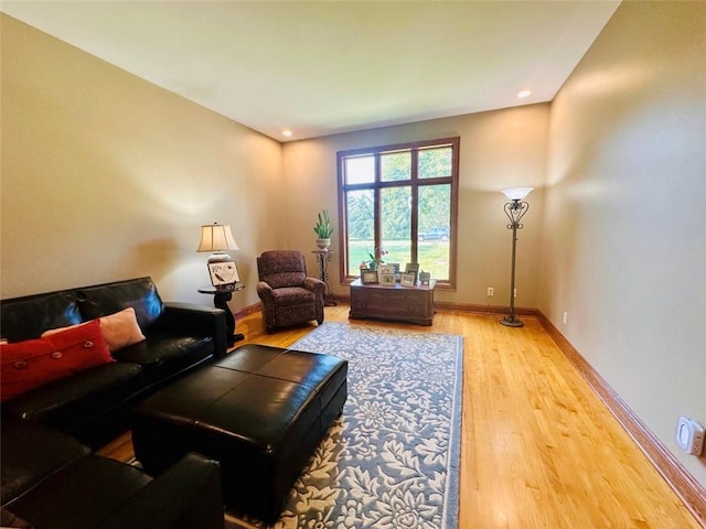 living room featuring recessed lighting, baseboards, and wood finished floors