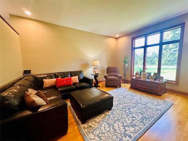 living area with recessed lighting, wood finished floors, and baseboards