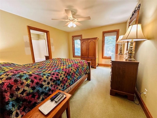 bedroom featuring baseboards, light carpet, and a ceiling fan