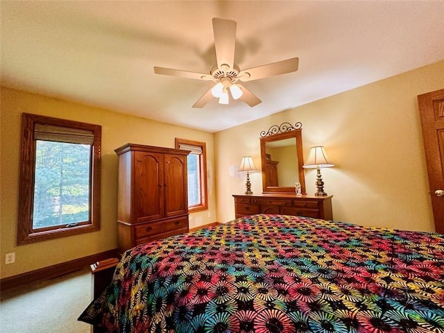 bedroom with a ceiling fan, carpet, and baseboards