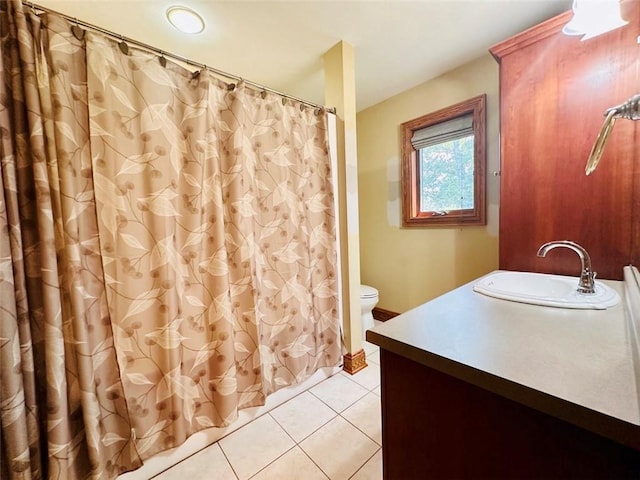 bathroom featuring tile patterned floors, toilet, vanity, and a shower with shower curtain