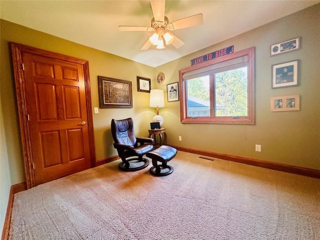 living area featuring carpet flooring, ceiling fan, visible vents, and baseboards