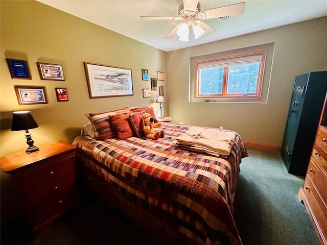 bedroom with dark colored carpet, baseboards, and ceiling fan