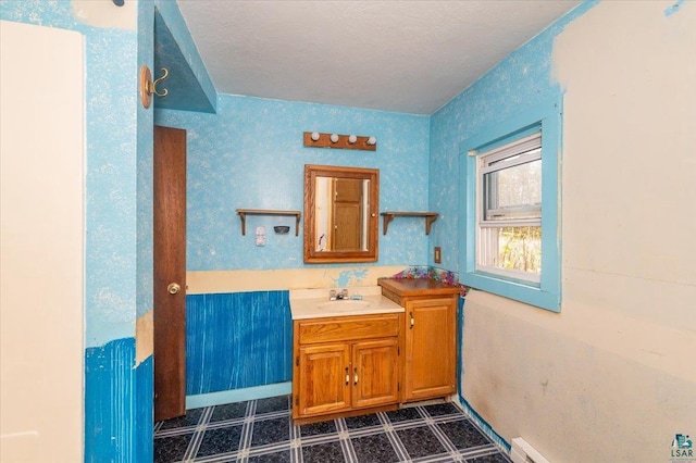 6275 S County Rd A, Superior, WI 54880 - bathroom featuring baseboards, wallpapered walls, and vanity