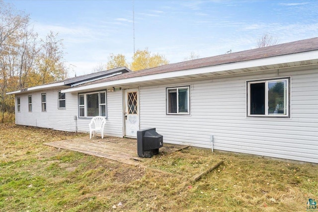 rear view of property with a lawn